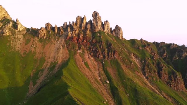 Aerial video of the sunrise in the Dolomites mountains. It was shot on the beautiful meadows of Seiser Alm plateau.