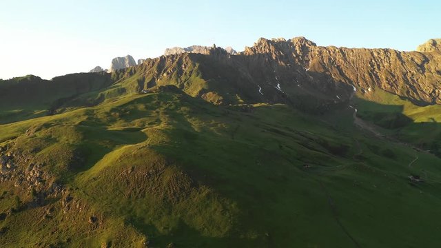 Aerial video of the sunrise in the Dolomites mountains. It was shot on the beautiful meadows of Seiser Alm plateau.