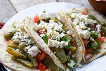Mexican nopal cactus  tacos with cheese on wooden background