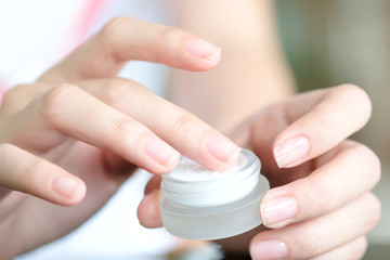 hands of a beautiful woman Dropping serum collagen moisturizer of face into clear yellow bottle soft light background. Protector skin Treatment facial essence oil, Vitamin C. Beauty and spa Con