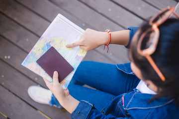 woman traveler holding passport and map