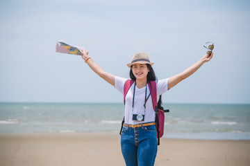 Traveling people concept. Young happy asian gril at the beach