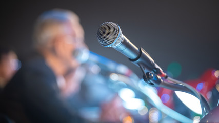 Business people talking on seminar panel with microphone