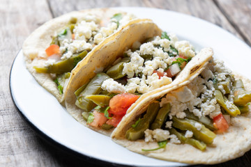 Mexican nopal cactus  tacos with cheese on wooden background