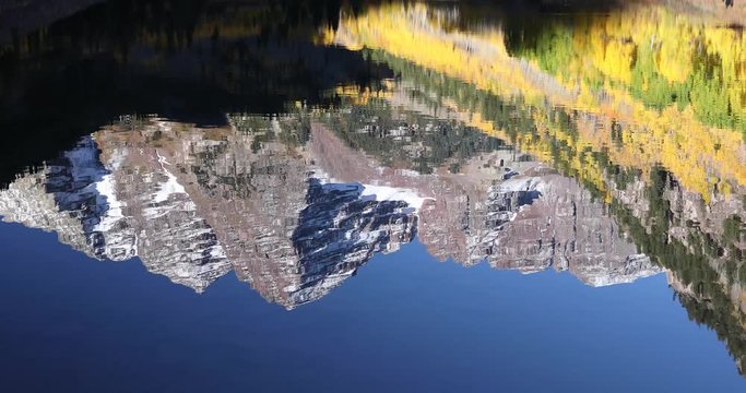 Maroon Bells Aspen Colorado. The Rocky Mountains reflect perfectly in Maroon Lake during peak fall colors. This is an upside down image of the Bells reflecting in Maroon Lake.