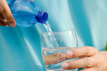 Clean water for good health. Pouring Fresh Pure Water From Pitcher Into A Glass on table wooden. Health And Diet Concept. Lifestyle Healthcare And Beauty.