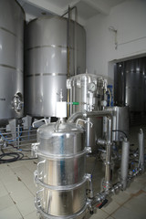 shiny tanks or barrels at a beer and wine factory. Industry Brewing and winemaking. Equipment for the winery and brewing industrial 