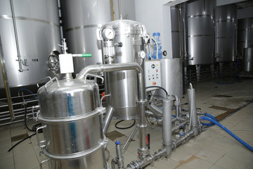 shiny tanks or barrels at a beer and wine factory. Industry Brewing and winemaking. Equipment for the winery and brewing industrial 