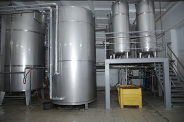 shiny tanks or barrels at a beer and wine factory. Industry Brewing and winemaking. Equipment for the winery and brewing industrial 
