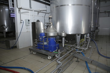 shiny tanks or barrels at a beer and wine factory. Industry Brewing and winemaking. Equipment for the winery and brewing