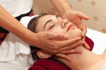 Fototapeta na wymiar Close up of Beautiful young woman is facial massage in a spa for.healthy and relaxing at spa