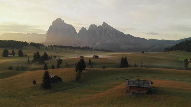 Aerial video of the sunrise in the Dolomites mountains. It was shot on the beautiful meadows of Seiser Alm plateau.