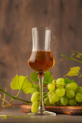Glass of grappa and fresh grapes