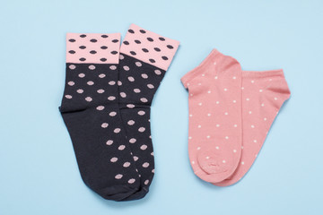 Two pair of women socks on blue background.