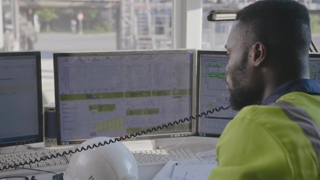 Engineer talking on phone in control room