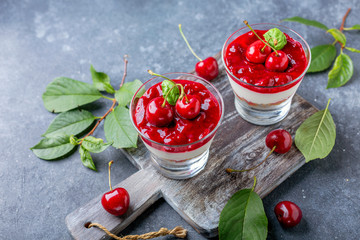 Sweet cherry cheesecake in glasses.