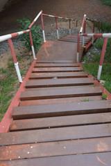 Rusty metal stairs with red and white color