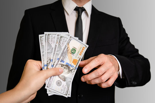 Man In A Suit Accepts Money. Business, Corruption, Law And Public Administration Concept