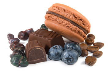 Cookies with chocolate candy and blueberries on a white background closeup.