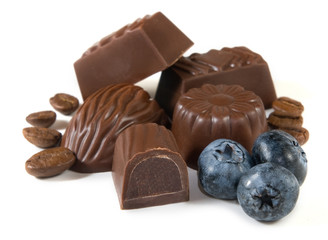 Cookies with chocolate candy and blueberries on a white background closeup.