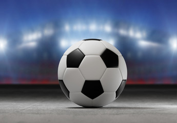 Fototapeta na wymiar Football ball on the field of a city stadium - 3d rendering