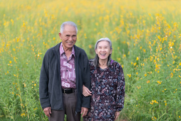 Happy old couple smiling in a park.mature couple.seniors lover family and healthcare concept.