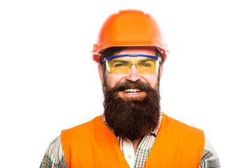Portrait of a builder smiling. Builder in hard hat, foreman or repairman in the helmet. Bearded man worker with beard in building helmet or hard hat. Man builders, industry. Building glasses