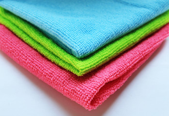  Three bright colored towels in a stack closeup