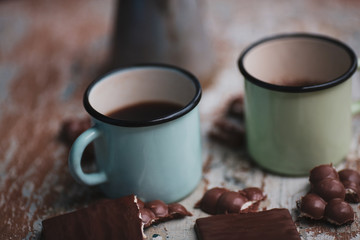 coffee in iron mugs and broken chocolate