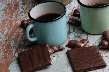 coffee in iron mugs and broken chocolate