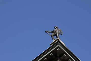 Statue of men on blu sky