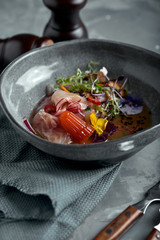 traditional peruvian food ceviche from seabass. Close-up, low key, gray background. Top view copy space