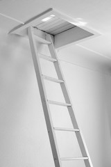 White old staircase to a closed wooden attic