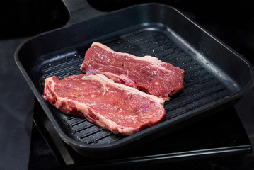 Beef fillet on grill , Beef steaks being prepared on grill , cooking meat steaks on kitchen.