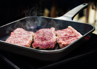 Beef fillet on grill , Beef steaks being prepared on grill , cooking meat steaks on kitchen.