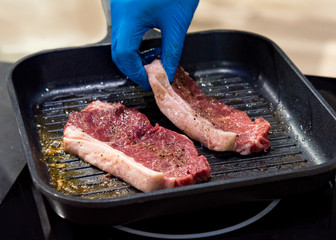 Beef fillet on grill , Beef steaks being prepared on grill , cooking meat steaks on kitchen.