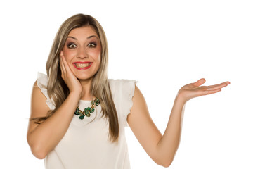 Obraz premium Happy woman posing with her empty hand on white background