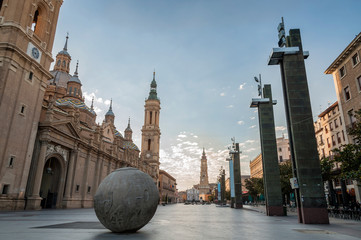 View of the Plaza de El Pilar de Zaragoza (Spain) with the Cathedral of El Pilar and the tower of the Cathedral of La Seo in the background, at dawn.