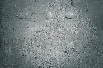 Urban concrete wall background with grooves and bubbles. Cement gray wall. Urban and industrialization art concept. Texture like concrete, stone, cement, plaster.. Poster mockup. Сloseup studio shot.