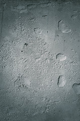 Urban concrete wall background with grooves and bubbles. Cement gray wall. Urban and industrialization art concept. Texture like concrete, stone, cement, plaster.. Poster mockup. Сloseup studio shot.