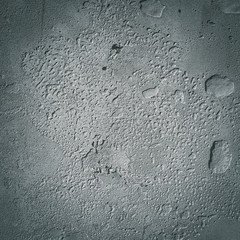 Urban concrete wall background with grooves and bubbles. Cement gray wall. Urban and industrialization art concept. Texture like concrete, stone, cement, plaster.. Poster mockup. Сloseup studio shot.