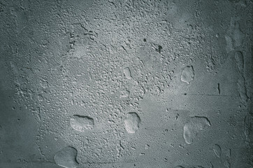 Urban concrete wall background with grooves and bubbles. Cement gray wall. Urban and industrialization art concept. Texture like concrete, stone, cement, plaster.. Poster mockup. Сloseup studio shot.