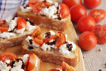Sandwiches with tomatoes, homemade cheese, olive oil and balsamic sauce