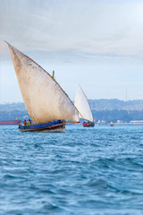 Obraz premium traditional dhow sailing vessel used to transport people goods and commodities heading to sea and the open ocean