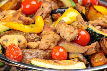 grilled meat with vegetables on a board close-up