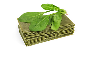 Uncooked green spinach lasagna sheets and fresh spinach