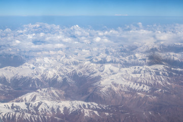 View of the Himalayas mountain through airplane window.