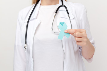 Female hand holding blue ribbon isolated