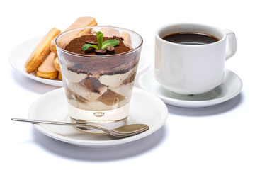 Classic tiramisu dessert in a glass cup, savoiardi cookies and espresso coffee on white background with clipping path