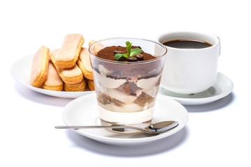 Classic tiramisu dessert in a glass cup, savoiardi cookies and espresso coffee on white background with clipping path